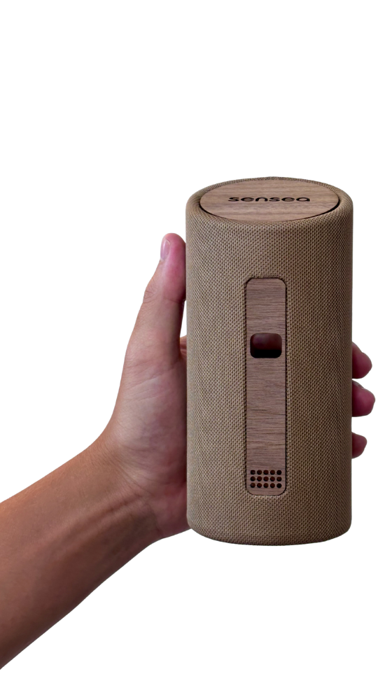 The sensea device shown on its own, a small matte cylinder with a wooden lid.
