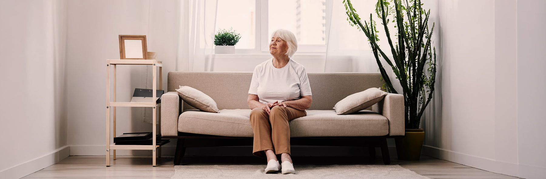 Portrait of an older woman at home, looking calm and content.
